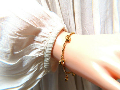 Five heart charm link bracelet 14 karat gold 7 inch
